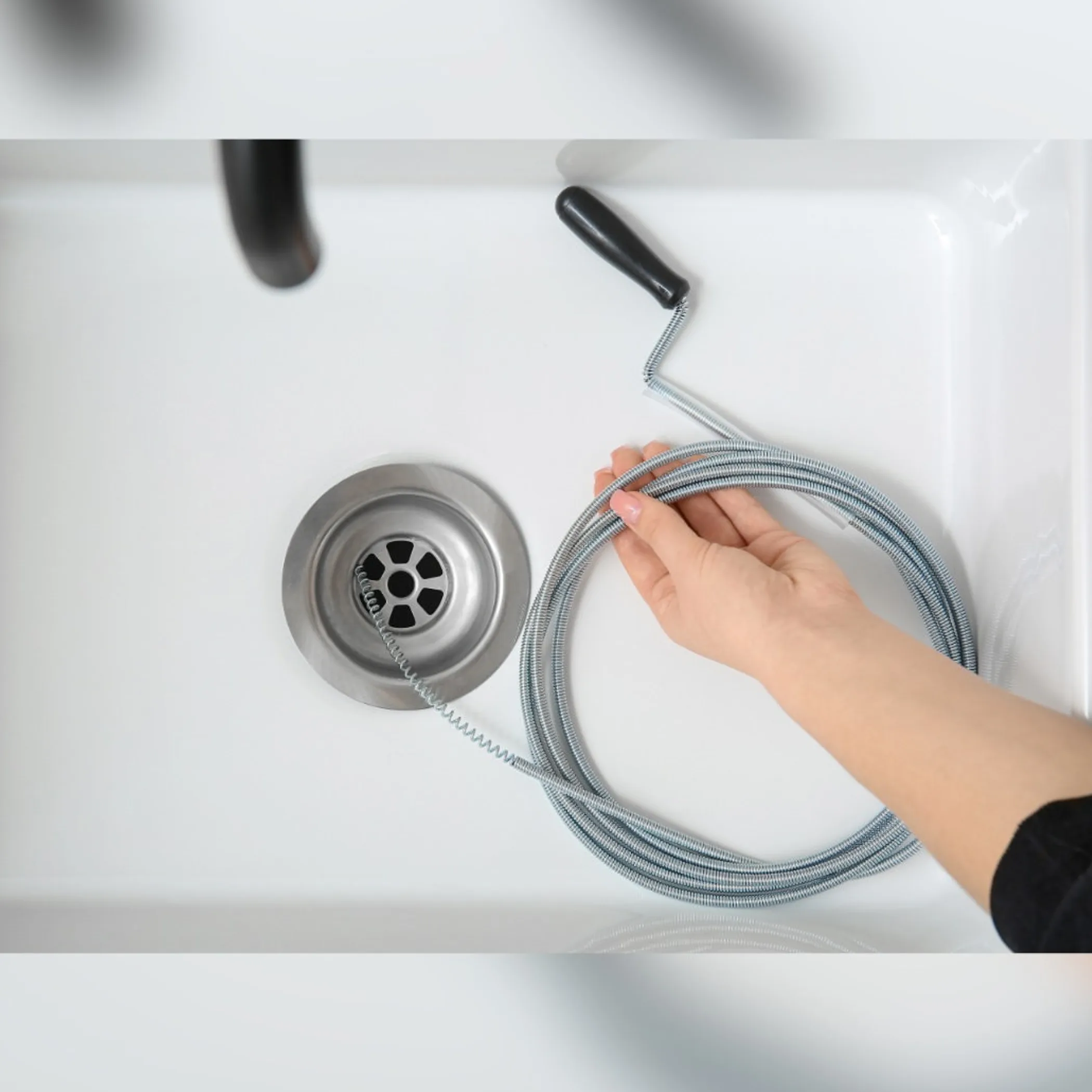 drain-cleaning snake in sink